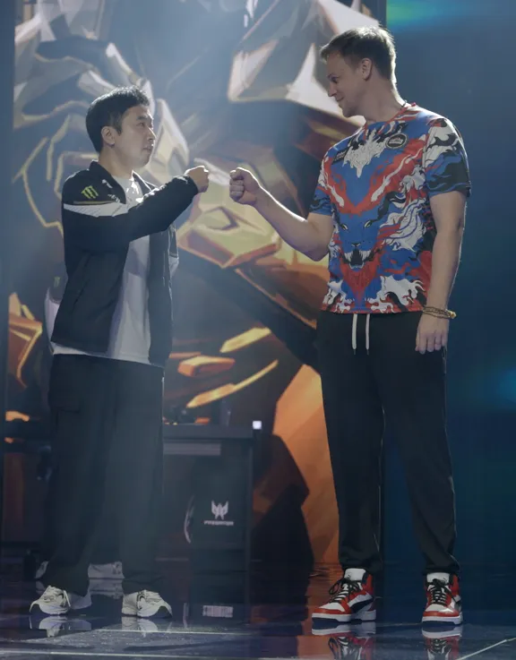 Donnie "Elevated" Chell on stage at a VCT Pacific event, fist-bumping the opposing coach